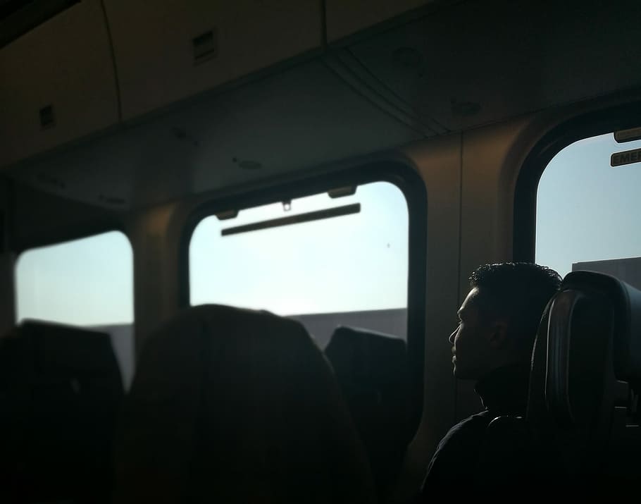 person sitting on train chair, man sitting in train seat, window HD wallpaper