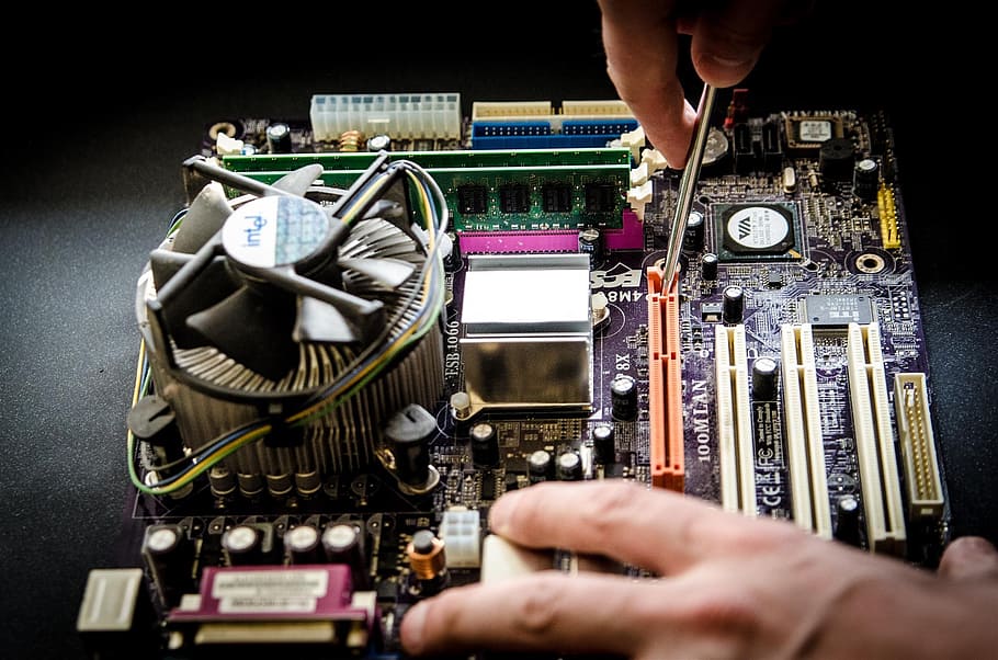 person holding screw fixing multicolored computer motherboard, HD wallpaper