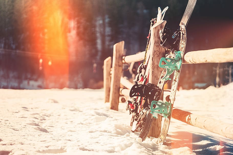 Snowboards and Skis Leaning Against Wooden Fence, active, cold, HD wallpaper
