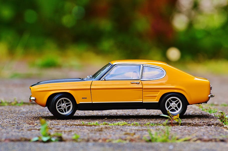 selective focus photography of yellow and black Ford Mustang coupe scale model HD wallpaper