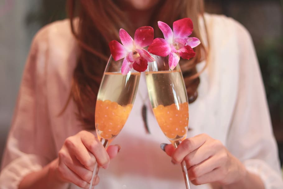 woman holding two champagne glasses, women, cocktail, adult, alcohol HD wallpaper