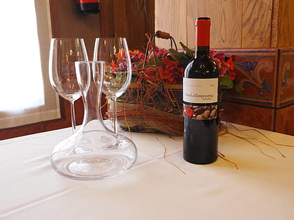 wine glass bottle next to clear glass wine container and wine glasses on table HD wallpaper