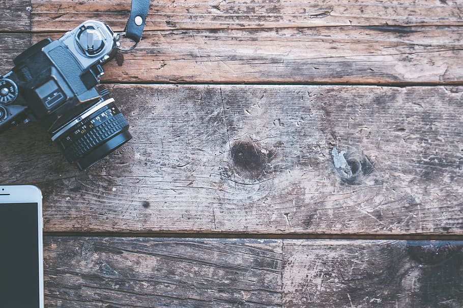 black DSLR camera on brown wood, apple, device, camera lens HD wallpaper