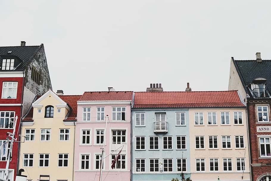 person taking picture of structures, high-rise assorted-color concrete building during daytime, HD wallpaper