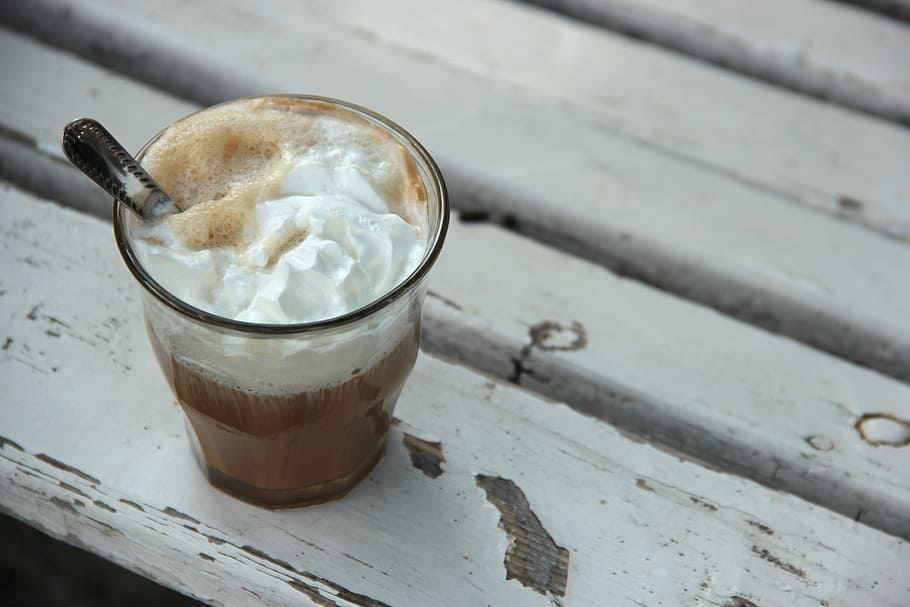 white cream in clear glass on white surface, coffee, whipped cream