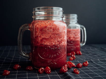 Mason Jar Filled With Cranberry Juice On Black and White Checked Cloth HD wallpaper