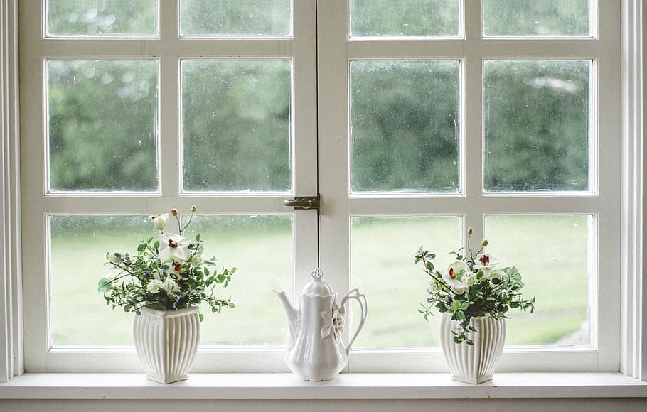 two white ceramic vases beside window pane, glass, shield, frame