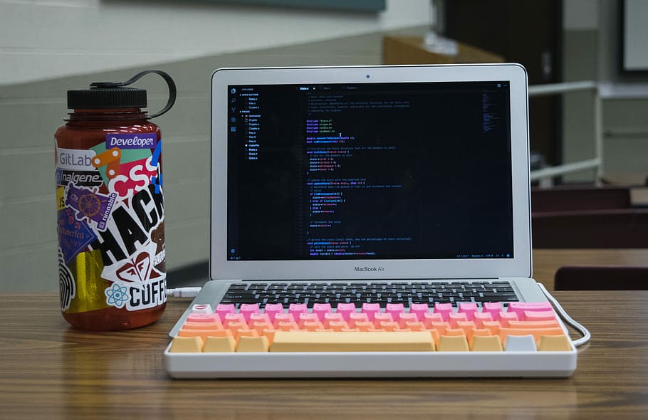 silver MacBook Air, MacBook Air beside plastic tumbler, laptop HD wallpaper