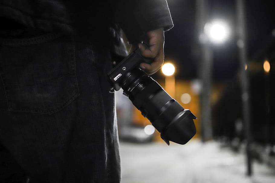 person holding black DSLR camera, lens, sony, street, photographer HD wallpaper