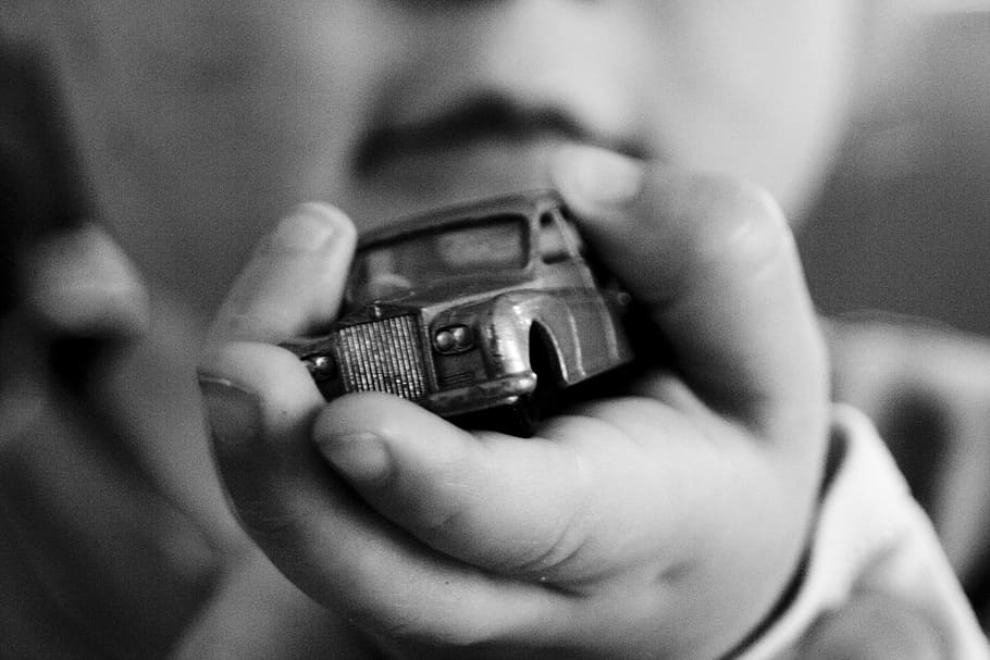 graycale photography of toddler holding car toy, childhood, kid