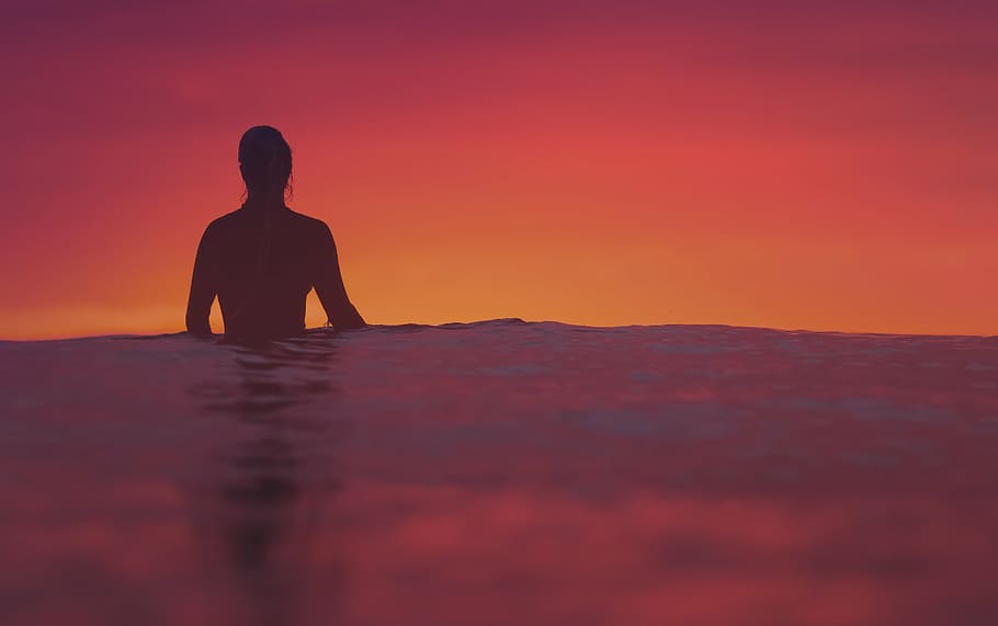 person submerge on water, silhouette, standing, ocean, sunset HD wallpaper