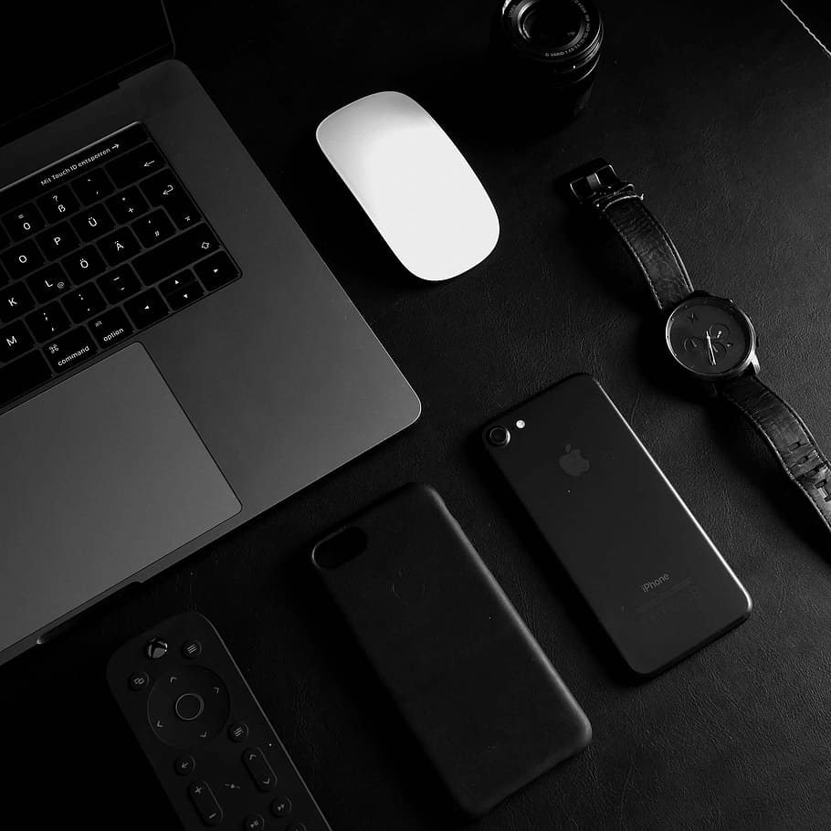 jet black iPhone 7 beside analog watch, round black chronograph watch beside black iPhone 7