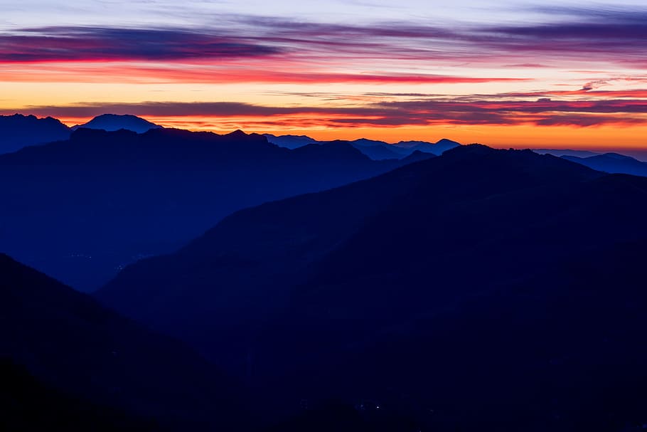 aerial view photography of mountains under cloudy sky during orange sunset HD wallpaper