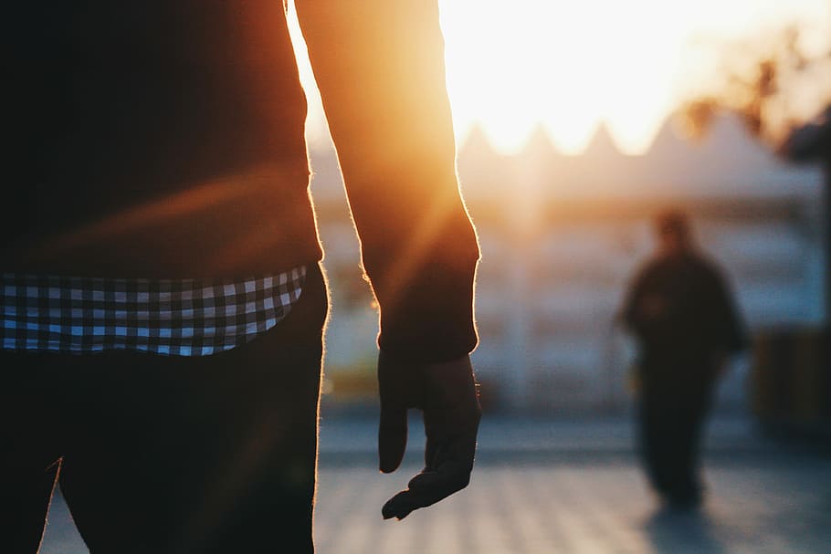 man standing during golden hours, person standing near person on front of white building HD wallpaper