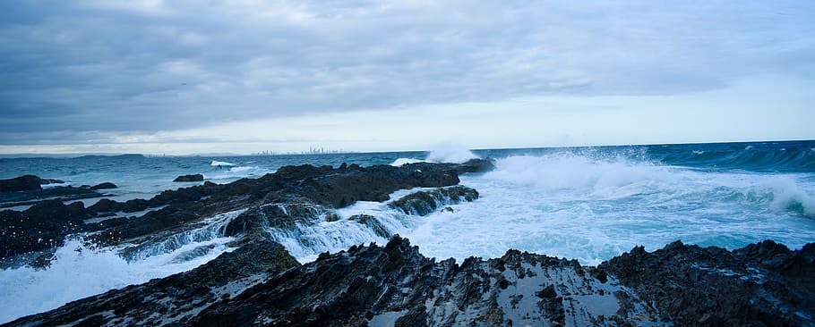 aerial photography of sea waves splashing on cove at daytime HD wallpaper