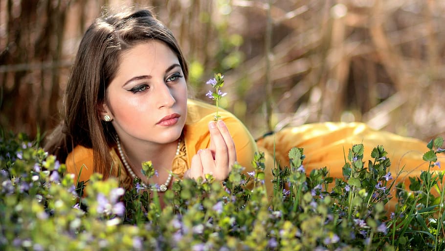 woman lying on grass field selective focus photo, girl, blue eyes
