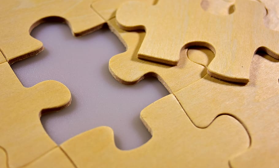 close-up photo of brown jigsaw puzzle, last part, wood, joining together