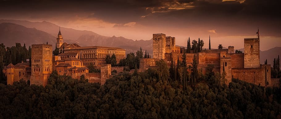 landscape photography of gray castle near green trees, alhambra