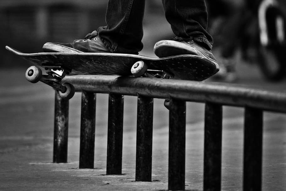 grayscale photography of person using skateboard on grindrail HD wallpaper