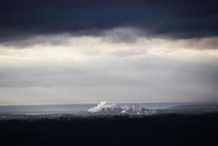 water waves on black shore under cloudy sky, aerial view of city under nimbus cloud HD wallpaper