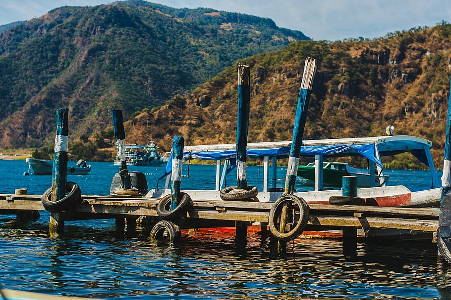 Colorful Docks of Lake Atitlán, boat beside dock on body of water during daytime HD wallpaper