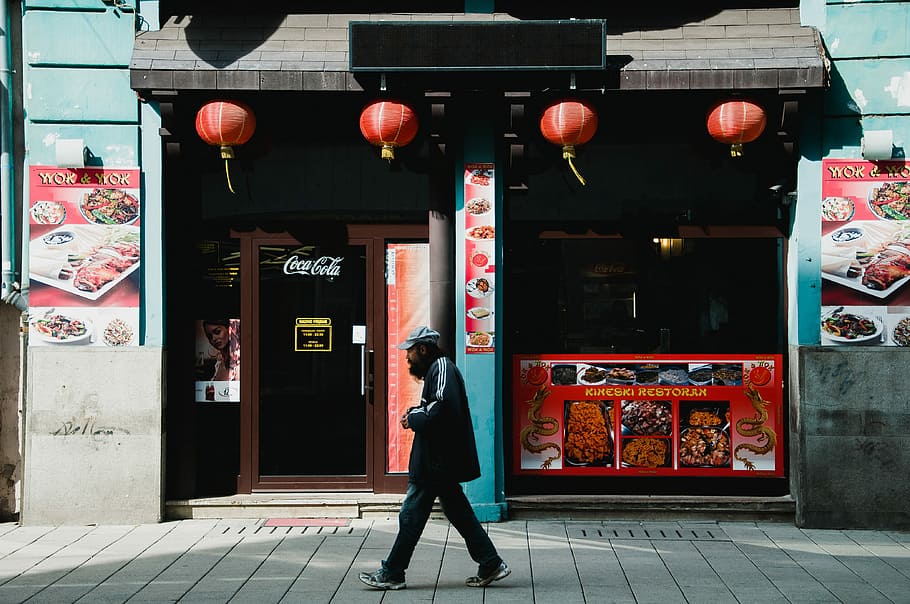 HD wallpaper: person walking on gray pavement, man walking on street beside food store during daytime - Wallpaper Flare
