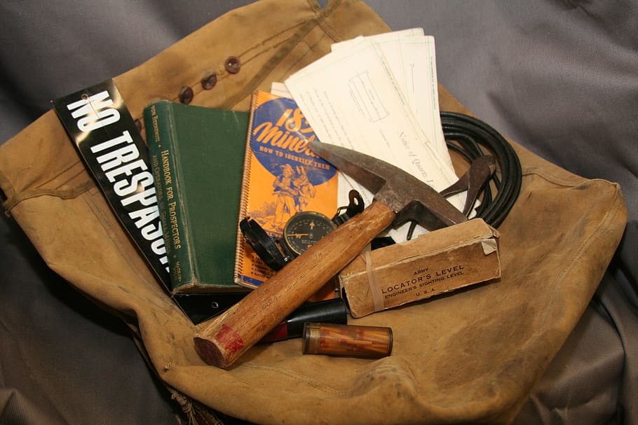 assorted mining tools on brown bag, adventure, maps, exploration HD wallpaper