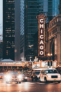 cars near buildings, Chicago store signage above white car, Chicago Theatre HD wallpaper