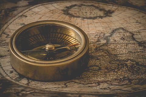 photo of gold-colored compass on brown map, degrees, north HD wallpaper