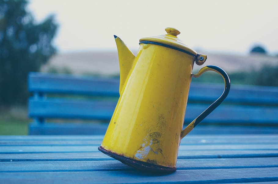 yellow kettle on gray wooden table, focus photo of yellow metal teapot on blue wooden board HD wallpaper