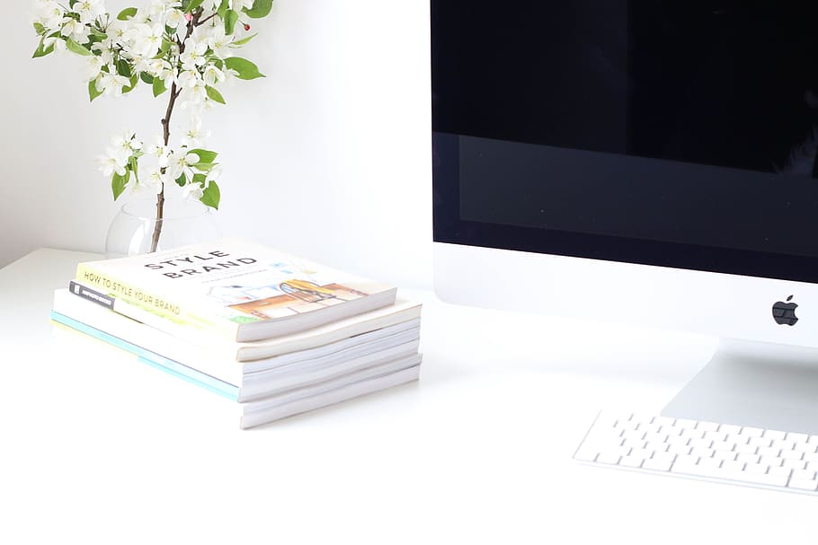 books beside white flowers and computer on desk, keyboard, apple HD wallpaper
