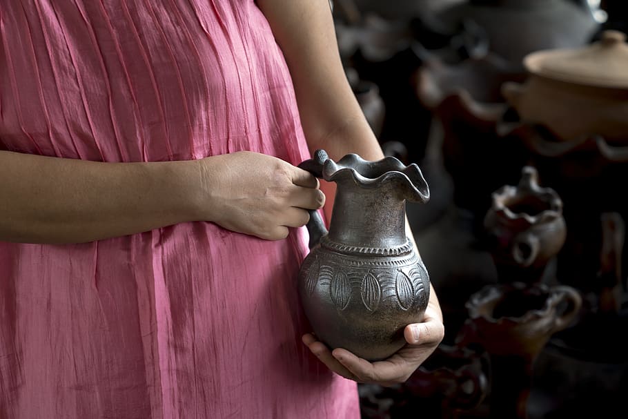 woman holding brown pitcher, adult, asia, pottery, circle, clay, HD wallpaper