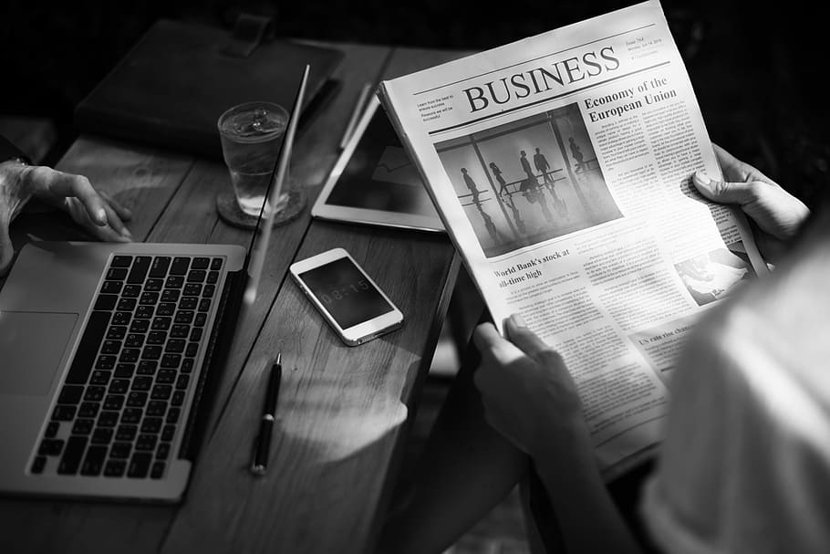 grayscale photo of man holding business paper beside table HD wallpaper