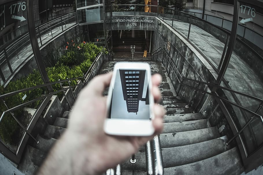 person holding white Android smartphone, person holding smartphone near stairs, HD wallpaper