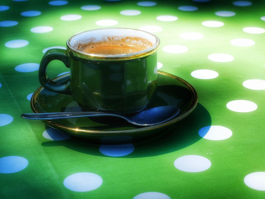 green ceramic cup filled with coffee, espresso, coffee drink