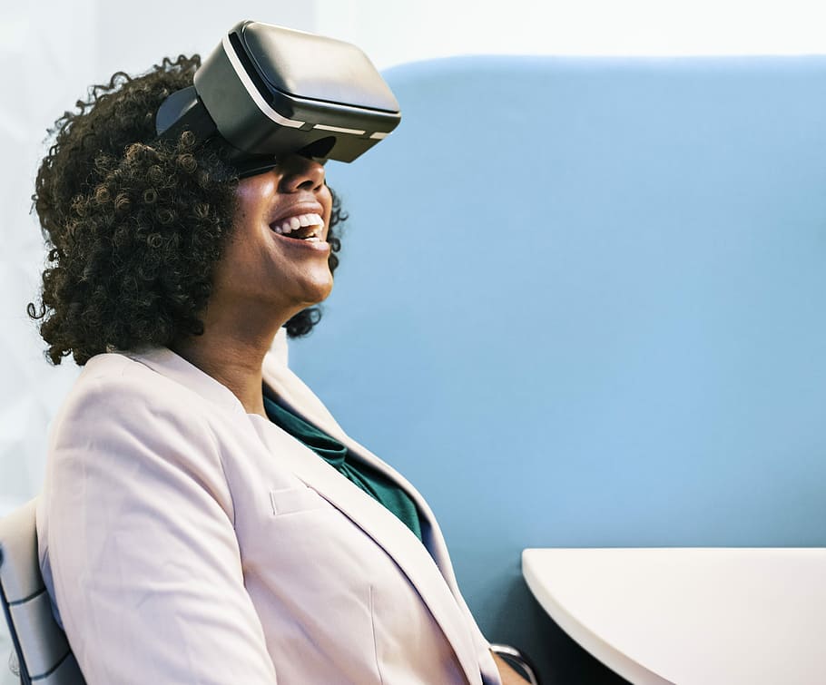 smiling woman using virtual reality headset at daytime, people