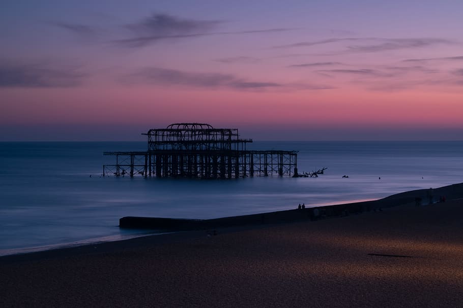silhouette of structure at shore during sunset, photo of seashore HD wallpaper
