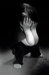 grayscale photo of boy in black pants face palming, sad, child HD wallpaper