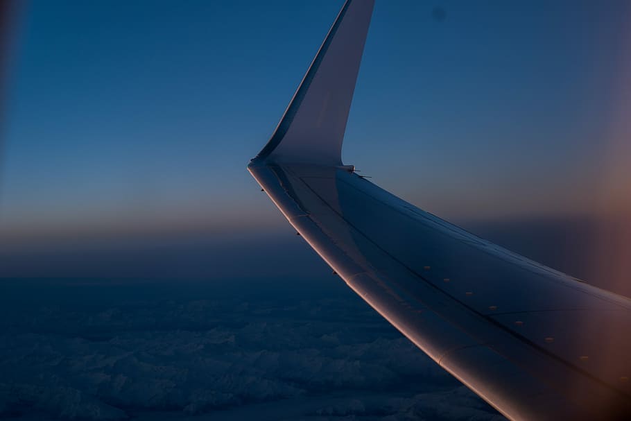 shallow focus photography of view inside plane, white plane wing