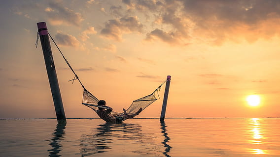 man lying in hammock above body of water during sunset, silhouette HD wallpaper
