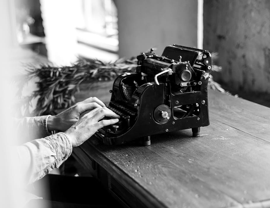 grayscale photo of person using typewriter, alphabet, ancient