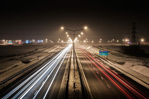 time lapse photography of moving vehicles on highway during night time HD wallpaper