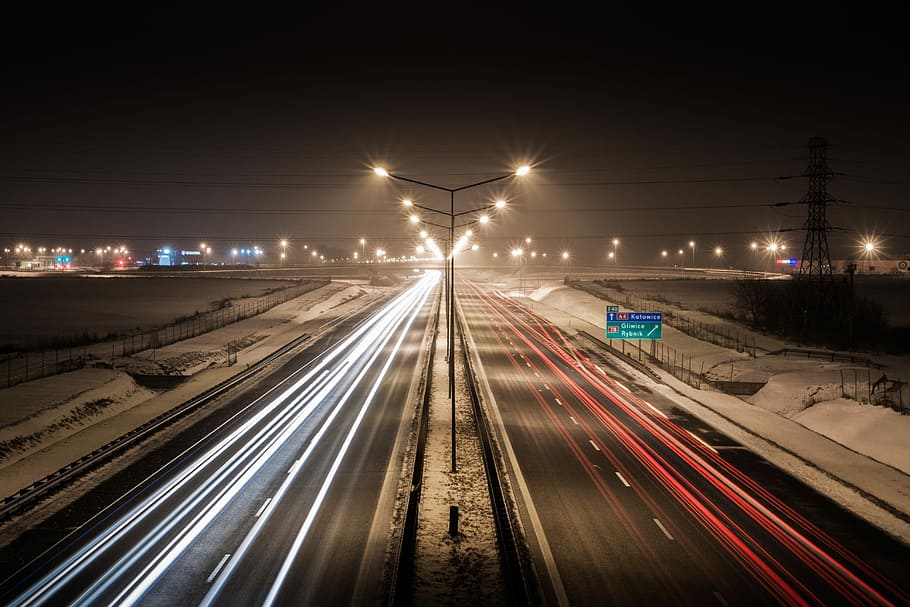 time lapse photography of moving vehicles on highway during night time HD wallpaper