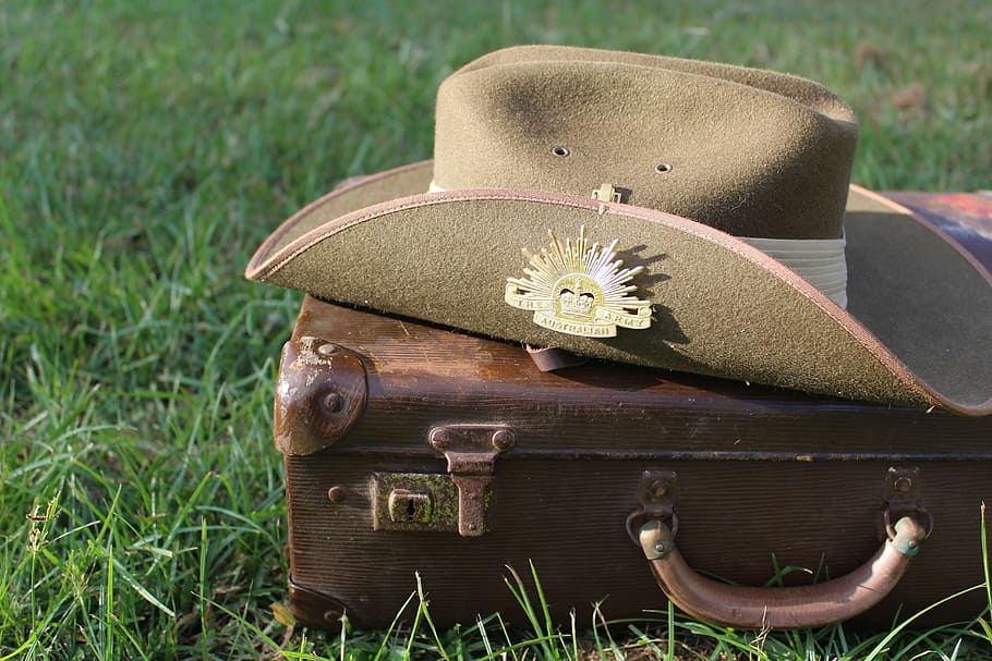 brown cowboy hat on top of brown luggage, australia, army, anzac