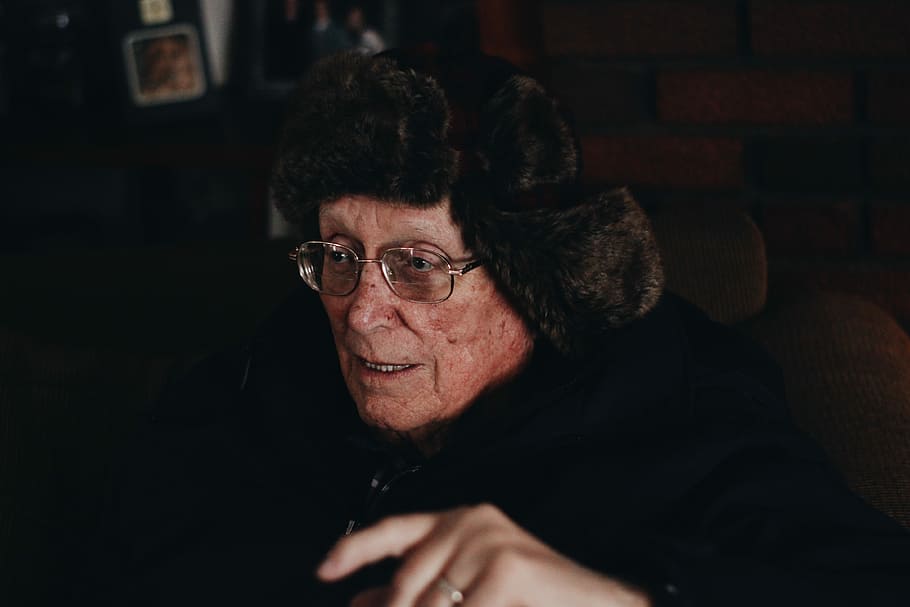 selective focus photo of man in black fur coat, woman sitting beside table, HD wallpaper