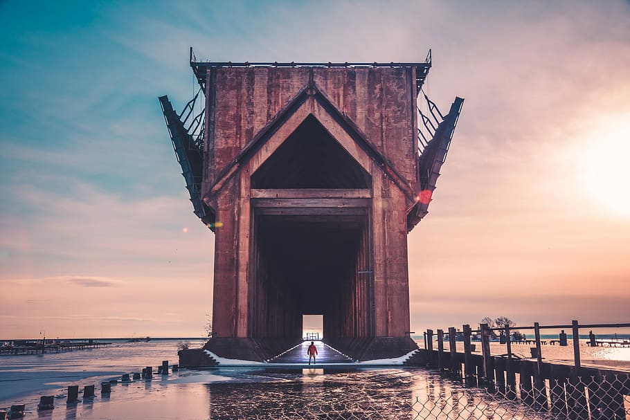 man standing on hallway during golden hour, man standing in front of the bridge HD wallpaper