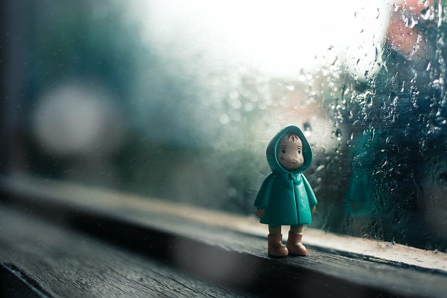 figurine beside glass window, rain, drops, water, toy, figure