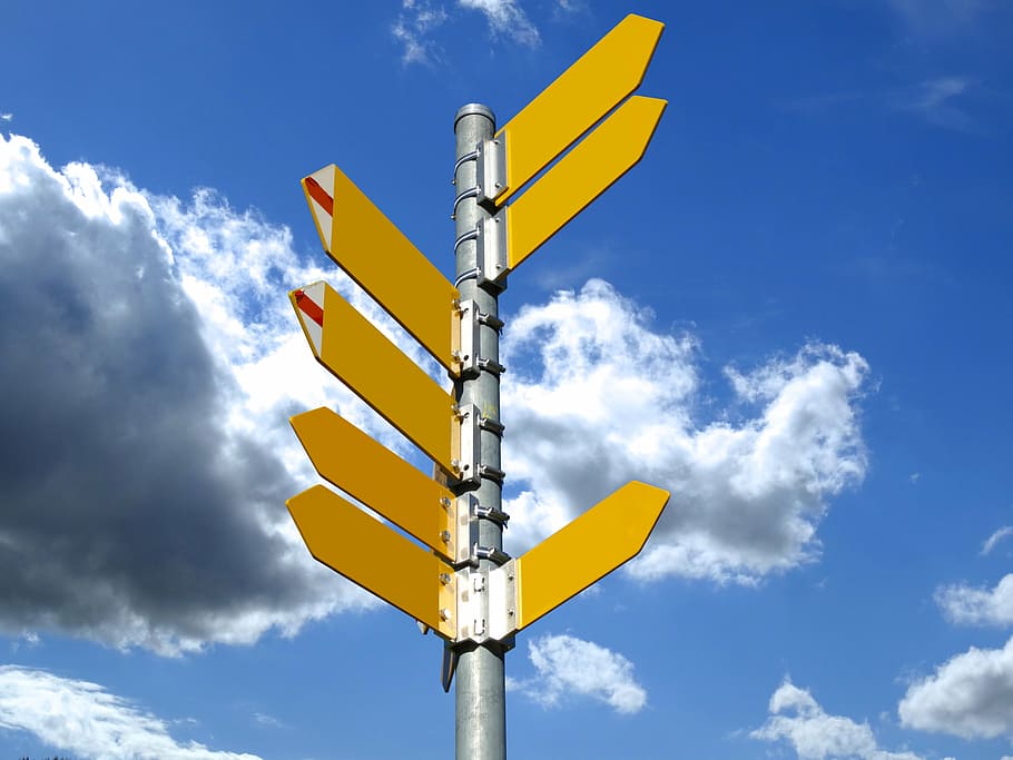 yellow left and right arrows signage under white clouds at daytime HD wallpaper