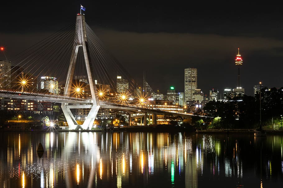 photography of city bridge during night, concrete bridge beside cityscape during night time HD wallpaper
