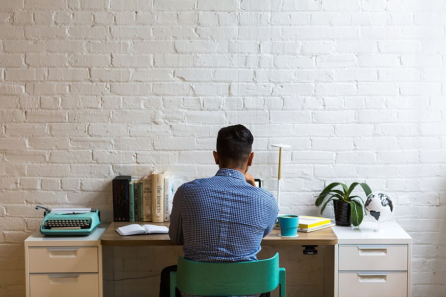 men's blue button-up dress shirt sitting on chair facing table HD wallpaper